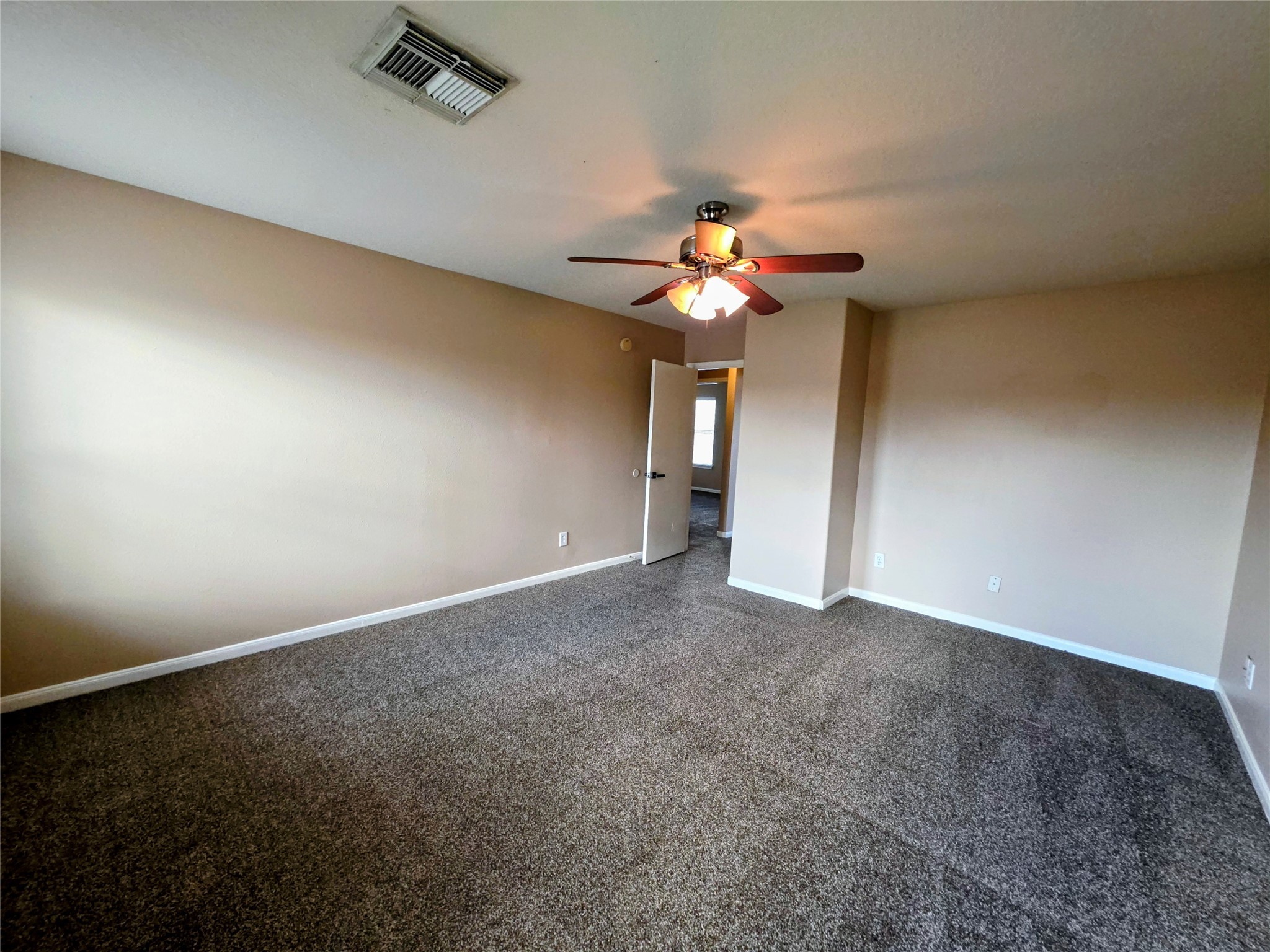 24235 Stargazer Point Spring, TX 77373 - Photo 18 of 21 an empty room with a chandelier fan and a chandelier fan