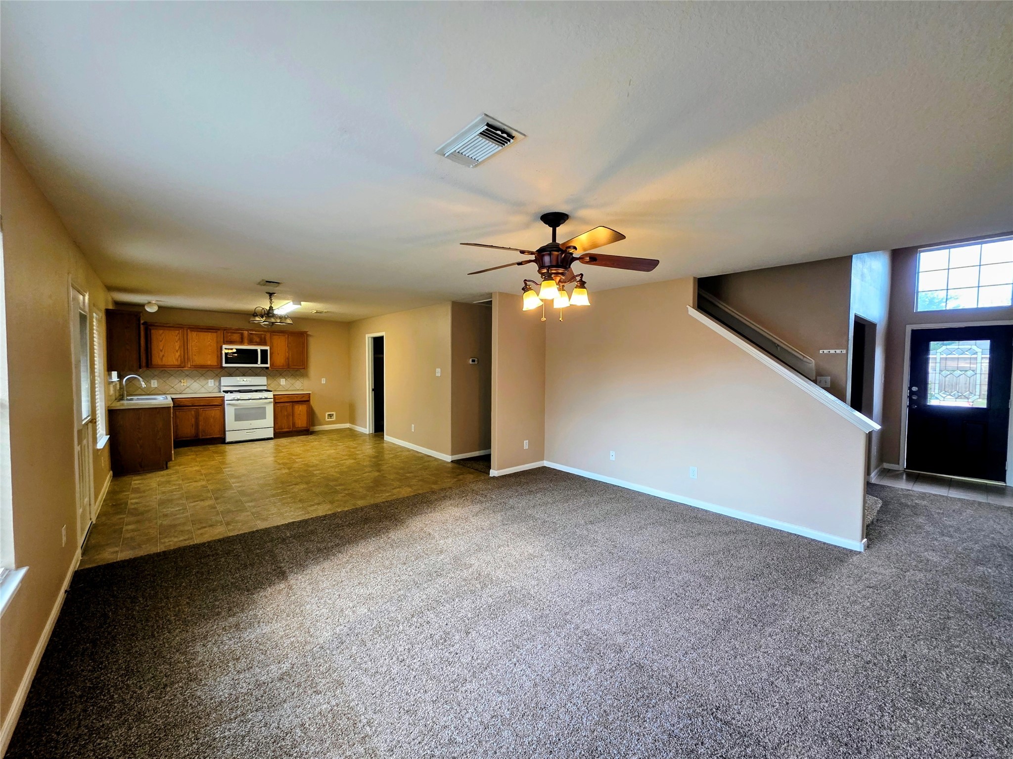 24235 Stargazer Point Spring, TX 77373 - Photo 3 of 21 a view of a kitchen with a sink and dishwasher next to a large window