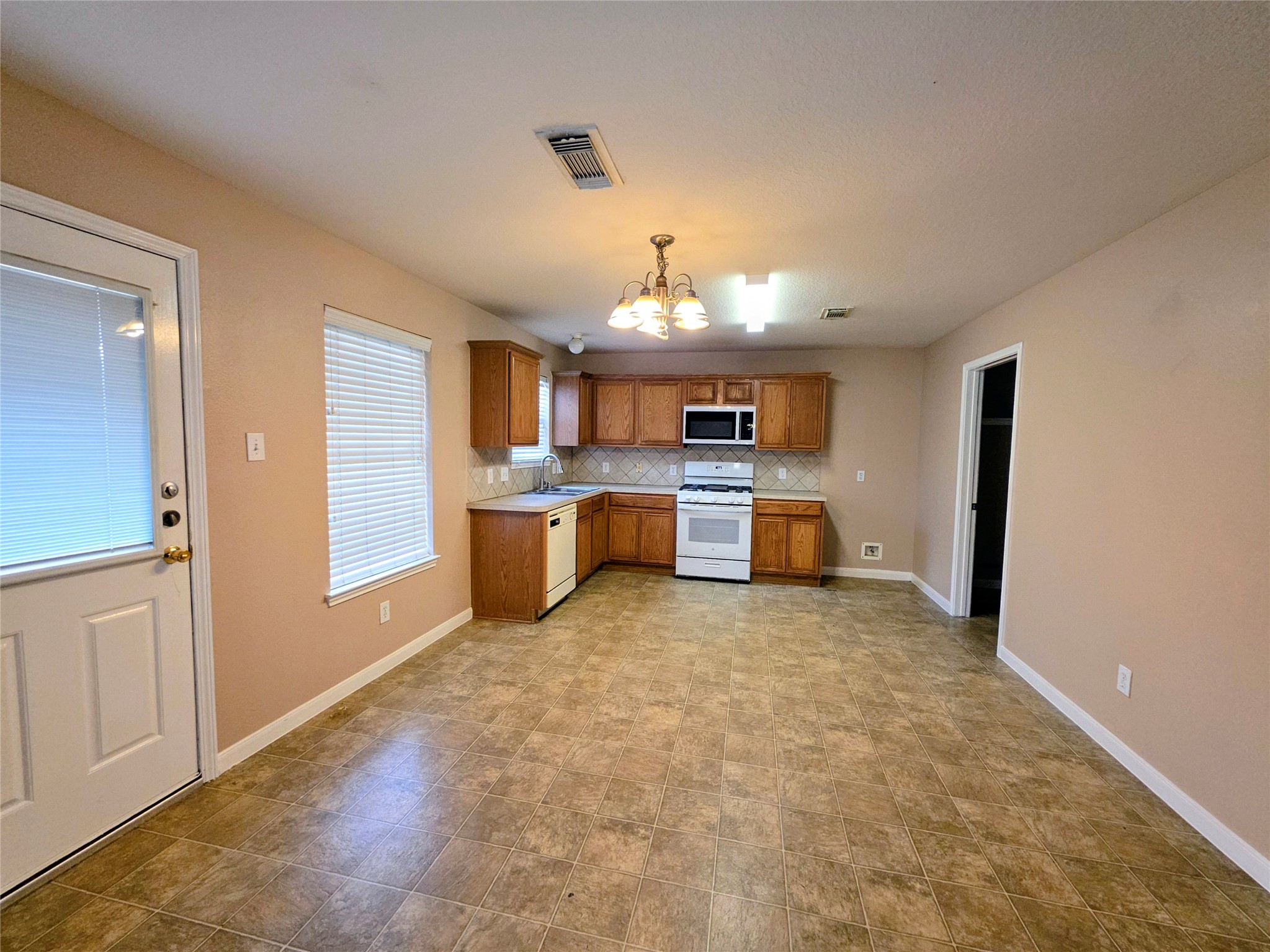 24235 Stargazer Point Spring, TX 77373 - Photo 5 of 21 a view of a kitchen with a sink cabinet cabinet and a refrigerator