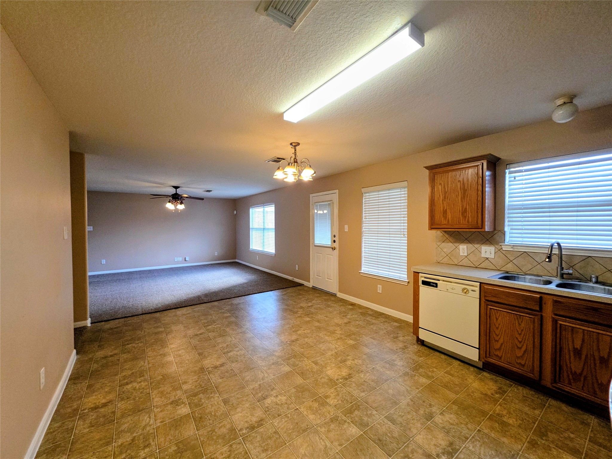 24235 Stargazer Point Spring, TX 77373 - Photo 6 of 21 a view of a kitchen with a sink and a refrigerator