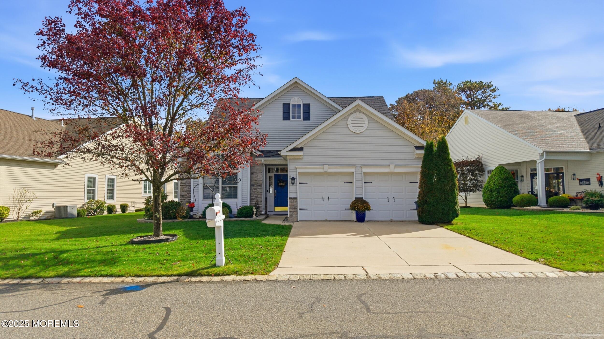 a front view of house with yard and green space