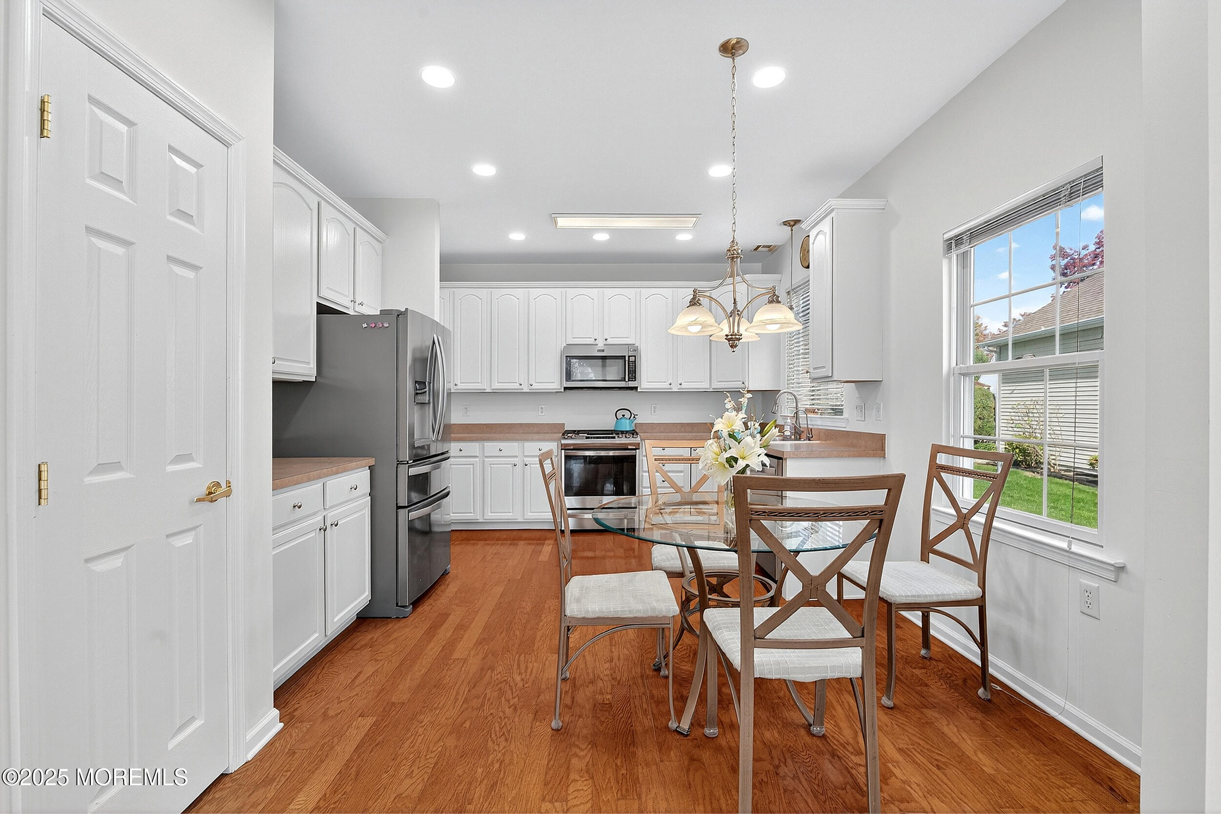 79 Spring Lake Boulevard Waretown, NJ 08758 - Photo 11 of 47 a kitchen with stainless steel appliances a dining table chairs stove and refrigerator