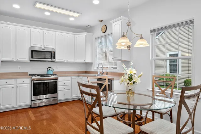 a view of a dining room with furniture and a kitchen