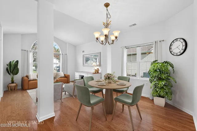 a view of a dining room with furniture and wooden floor