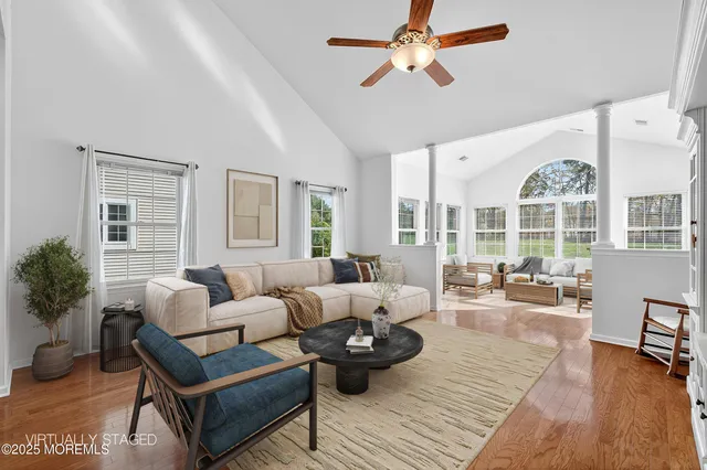 a living room with furniture and wooden floor