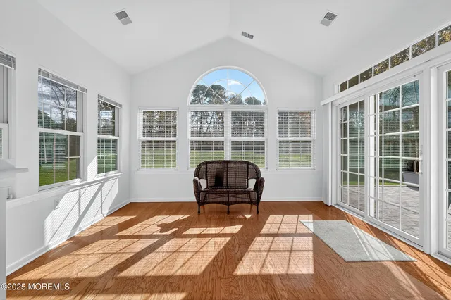 a living room with a large window and chandelier