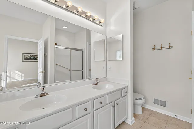 a bathroom with a double vanity sink and a mirror