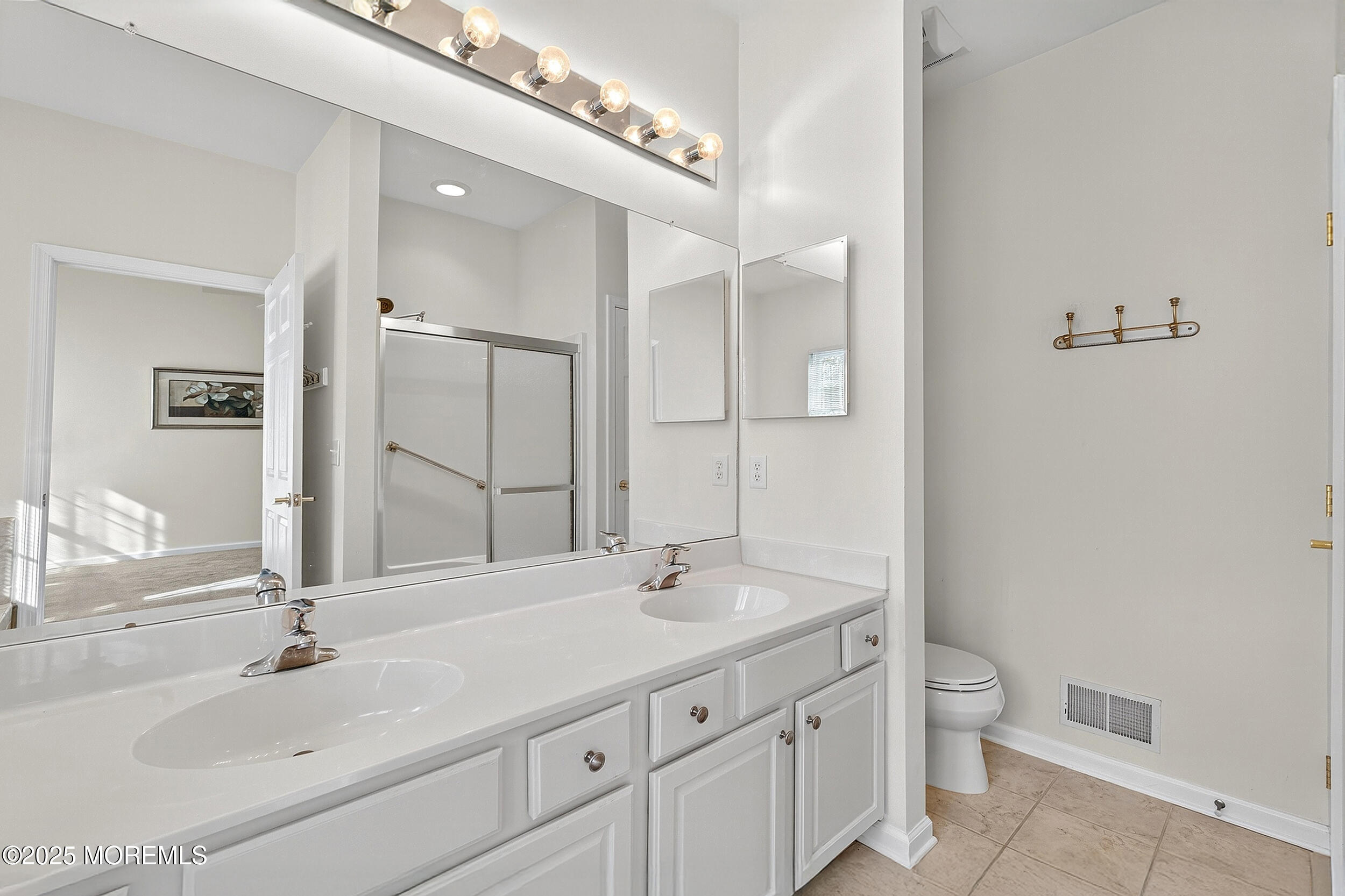 79 Spring Lake Boulevard Waretown, NJ 08758 - Photo 23 of 47 a bathroom with a double vanity sink and a mirror