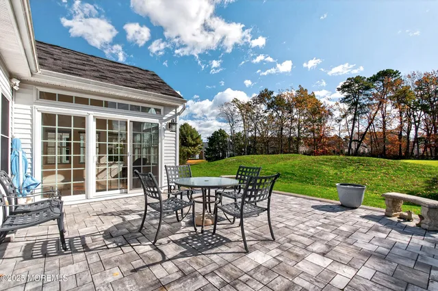 a view of a house with backyard sitting area and garden