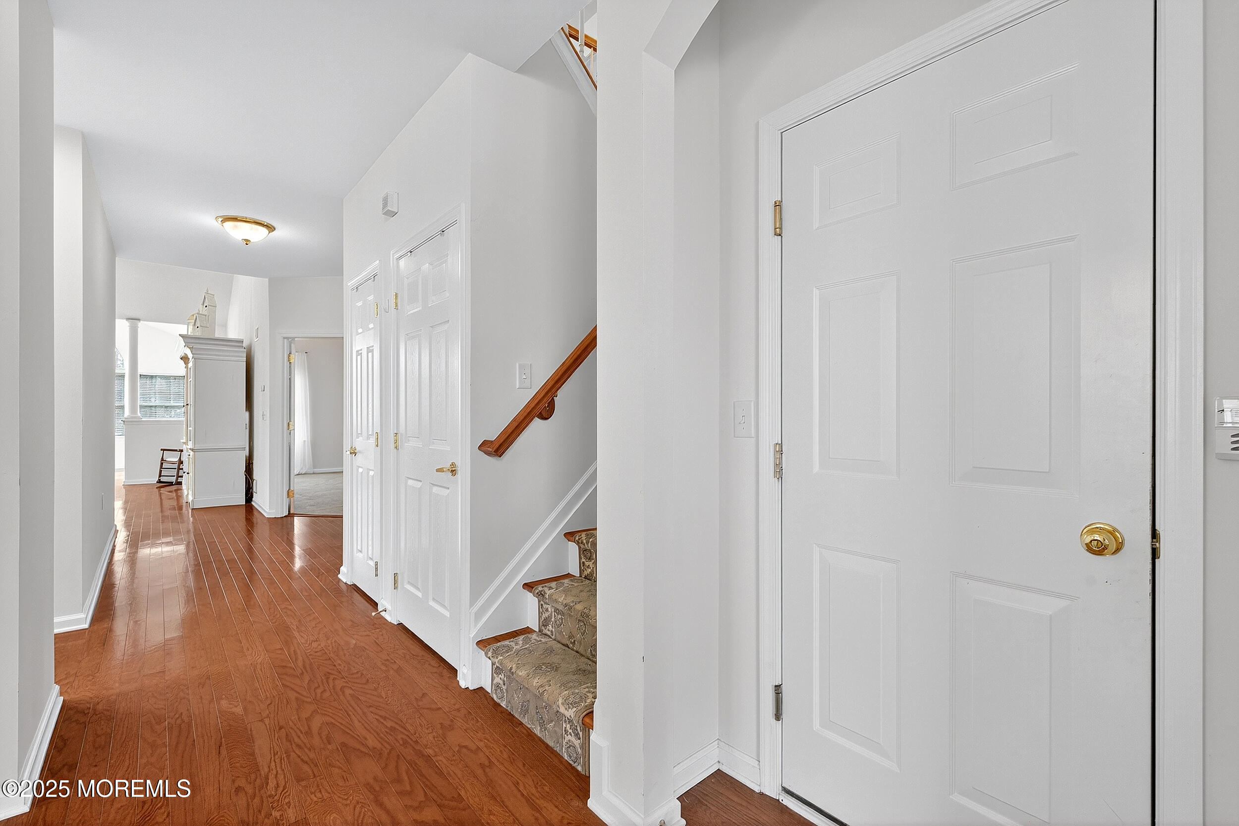 79 Spring Lake Boulevard Waretown, NJ 08758 - Photo 9 of 47 a view of a hallway with wooden floor and staircase