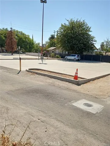 a view of a tennis ground with palm trees