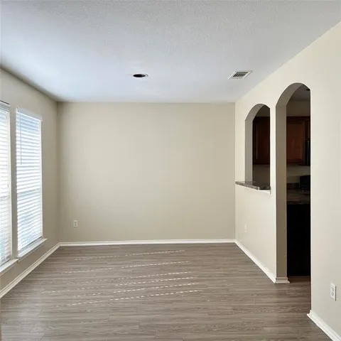 a view of room with window and wooden floor