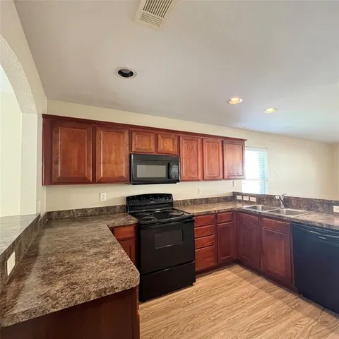 a kitchen with a sink and a stove top oven