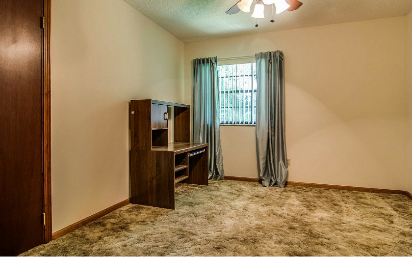 75043 Edwards Road Yulee, FL 32097 - Photo 13 of 21 an empty room with chandelier fan and windows