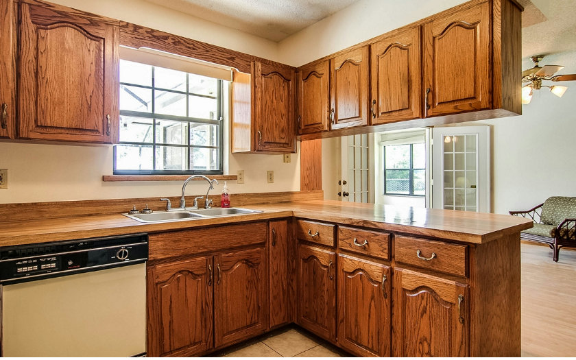 75043 Edwards Road Yulee, FL 32097 - Photo 6 of 21 a kitchen with stainless steel appliances granite countertop a sink stove and cabinets