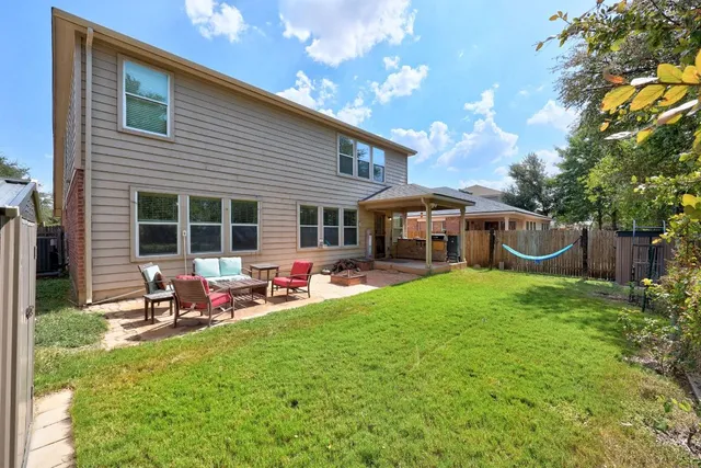 a front view of a house with a garden and patio