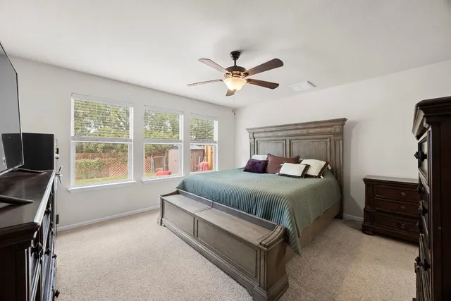 a bedroom with a bed and a tv