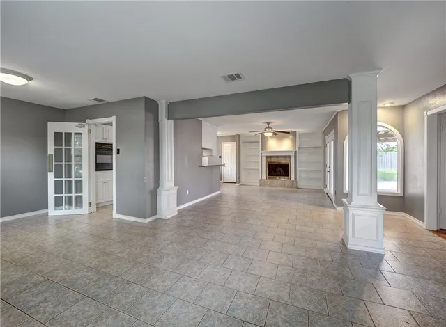 wooden floor in an empty room with a fireplace