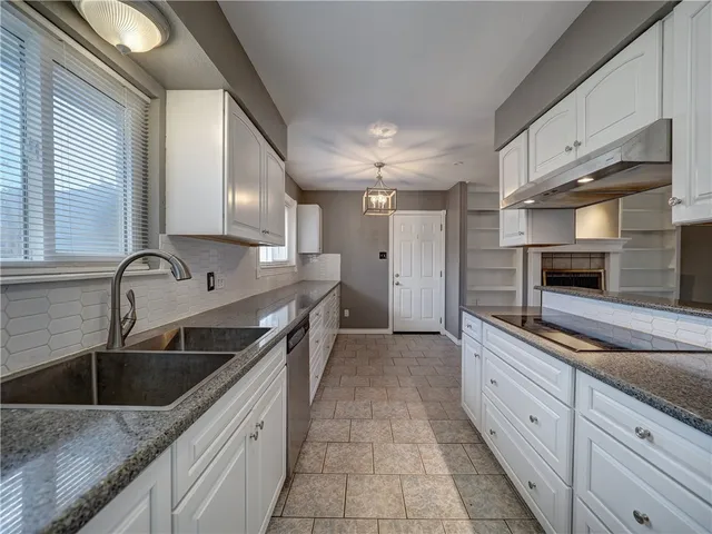 a kitchen with stainless steel appliances granite countertop a sink stove and cabinets