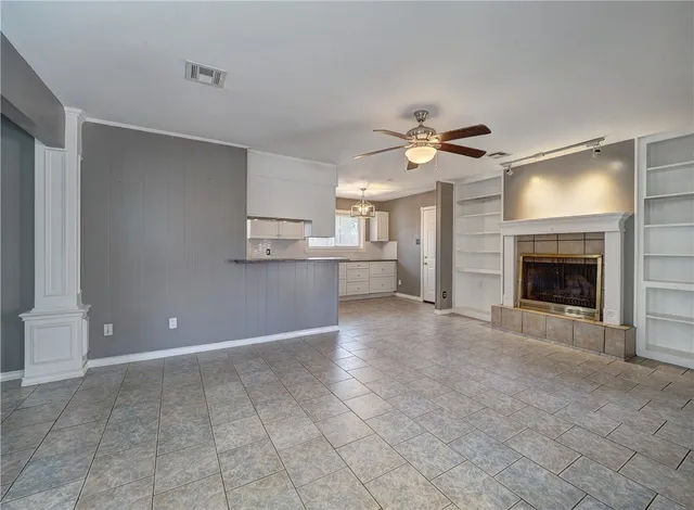 a view of a kitchen with a sink and a fireplace
