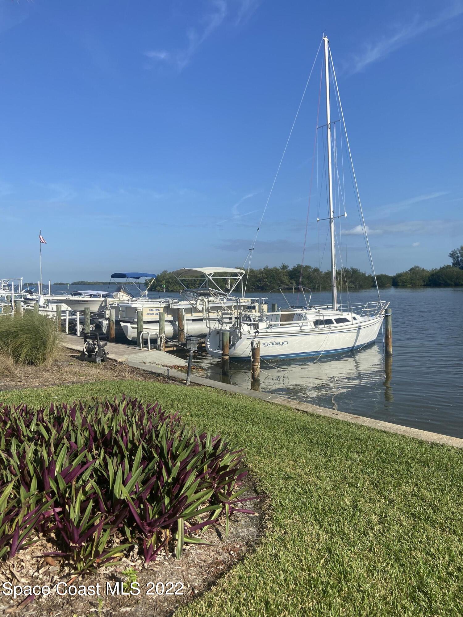 1611 Minutemen Causeway, Unit 207 Cocoa Beach, FL 32931 - Photo 2 of 11 a view of a lake with boats and trees in the background