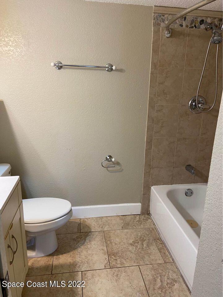 1611 Minutemen Causeway, Unit 207 Cocoa Beach, FL 32931 - Photo 8 of 11 a bathroom with a toilet and a shower