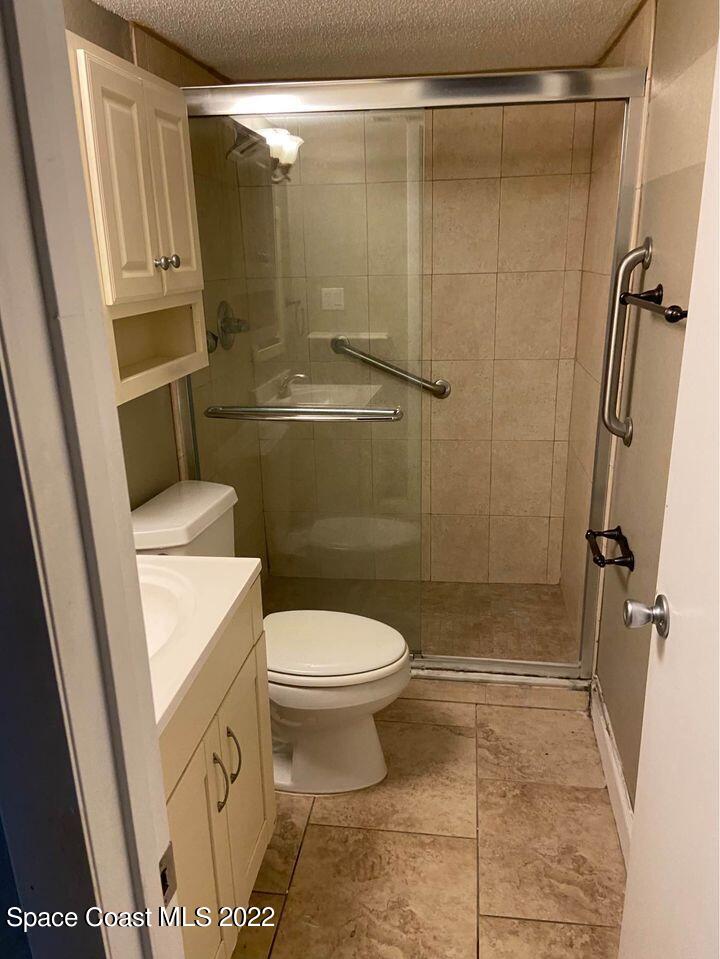 1611 Minutemen Causeway, Unit 207 Cocoa Beach, FL 32931 - Photo 10 of 11 a bathroom with a toilet and shower