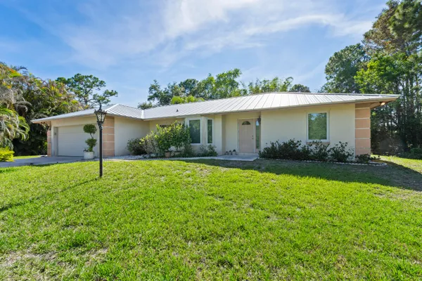 a view of a house with backyard and garden