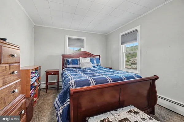 a bed sitting in a bedroom next to a window