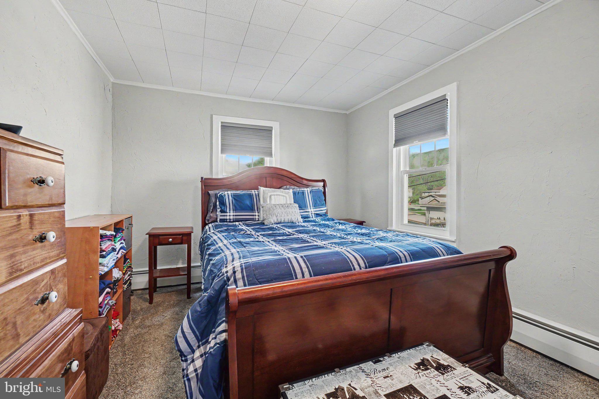 418 Elizabeth Street Williamstown, PA 17098 - Photo 15 of 34 a bed sitting in a bedroom next to a window