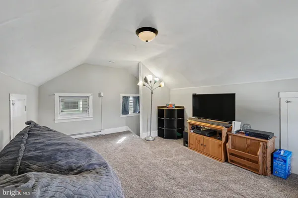 a bedroom with furniture and flat screen tv