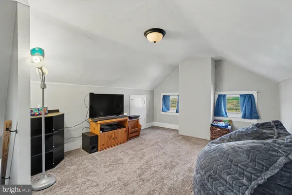 a bedroom with furniture and flat screen tv
