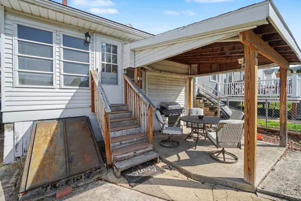 a view of deck with chairs and floor to ceiling window