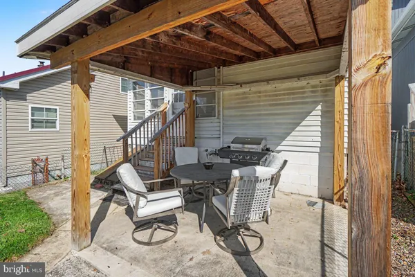 a view of a patio with a table and chairs