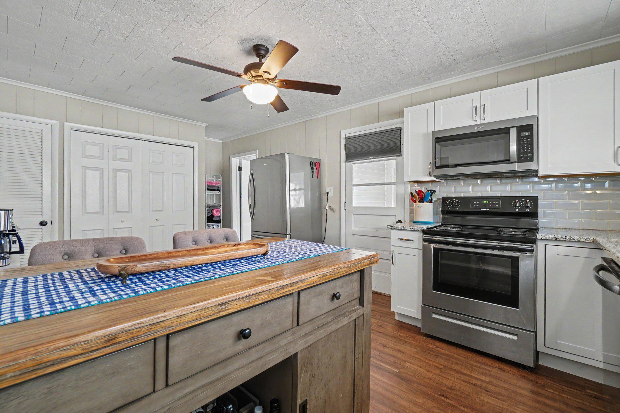 418 Elizabeth Street Williamstown, PA 17098 - Photo 3 of 34 a kitchen with stainless steel appliances kitchen island granite countertop a sink and cabinets