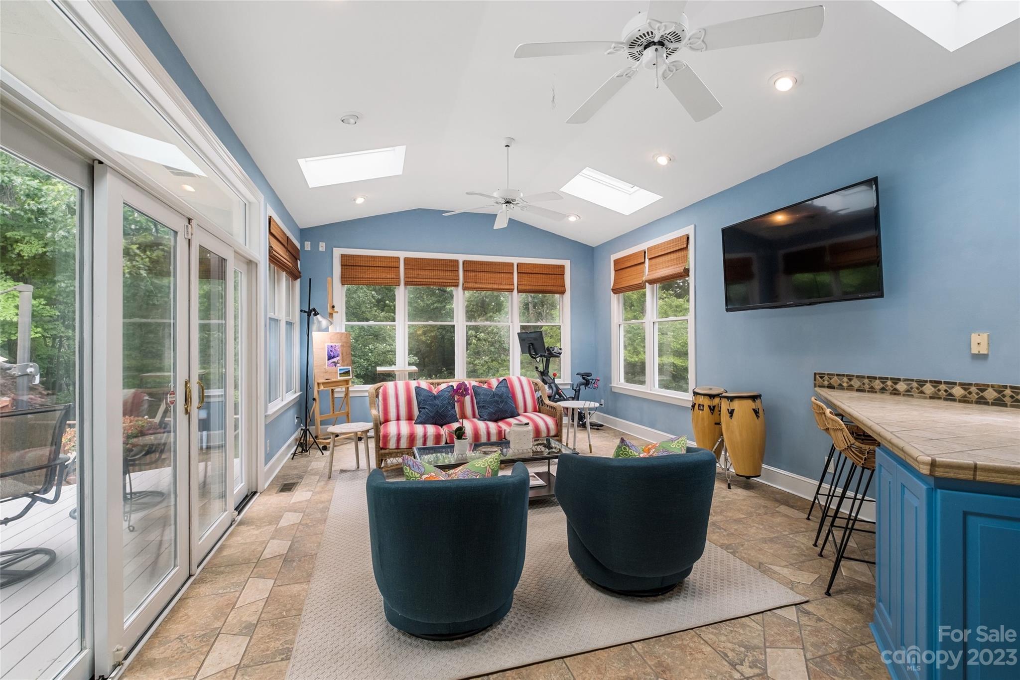 5013 Morrowick Road Charlotte, NC 28226 - Photo 16 of 48 a living room with couch a flat screen tv and a large window
