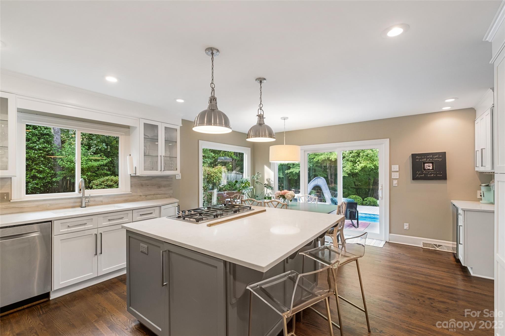 5013 Morrowick Road Charlotte, NC 28226 - Photo 19 of 48 a kitchen with a stove a sink a dining table and chairs