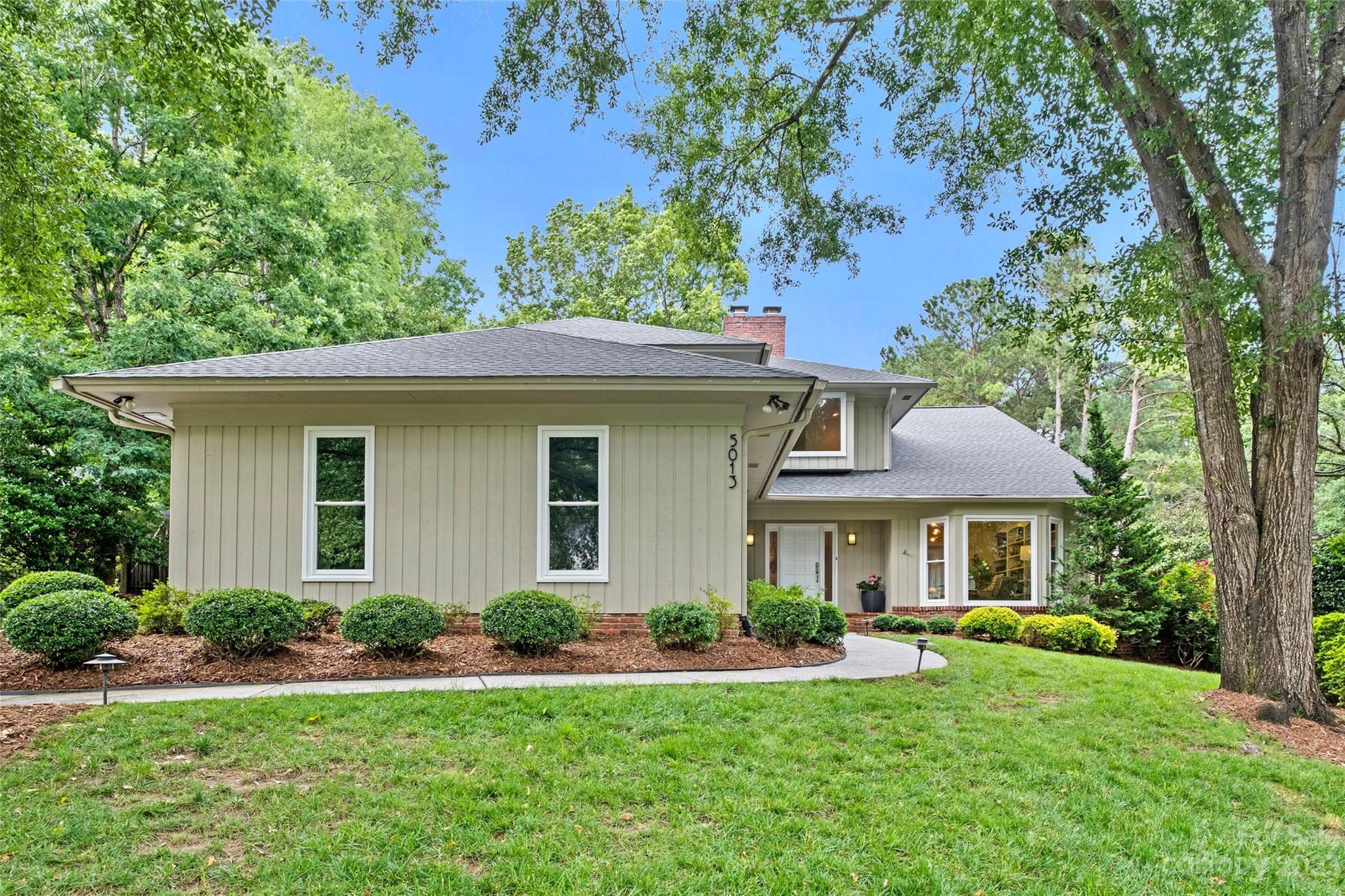 5013 Morrowick Road Charlotte, NC 28226 - Photo 2 of 48 a front view of a house with yard patio and green space