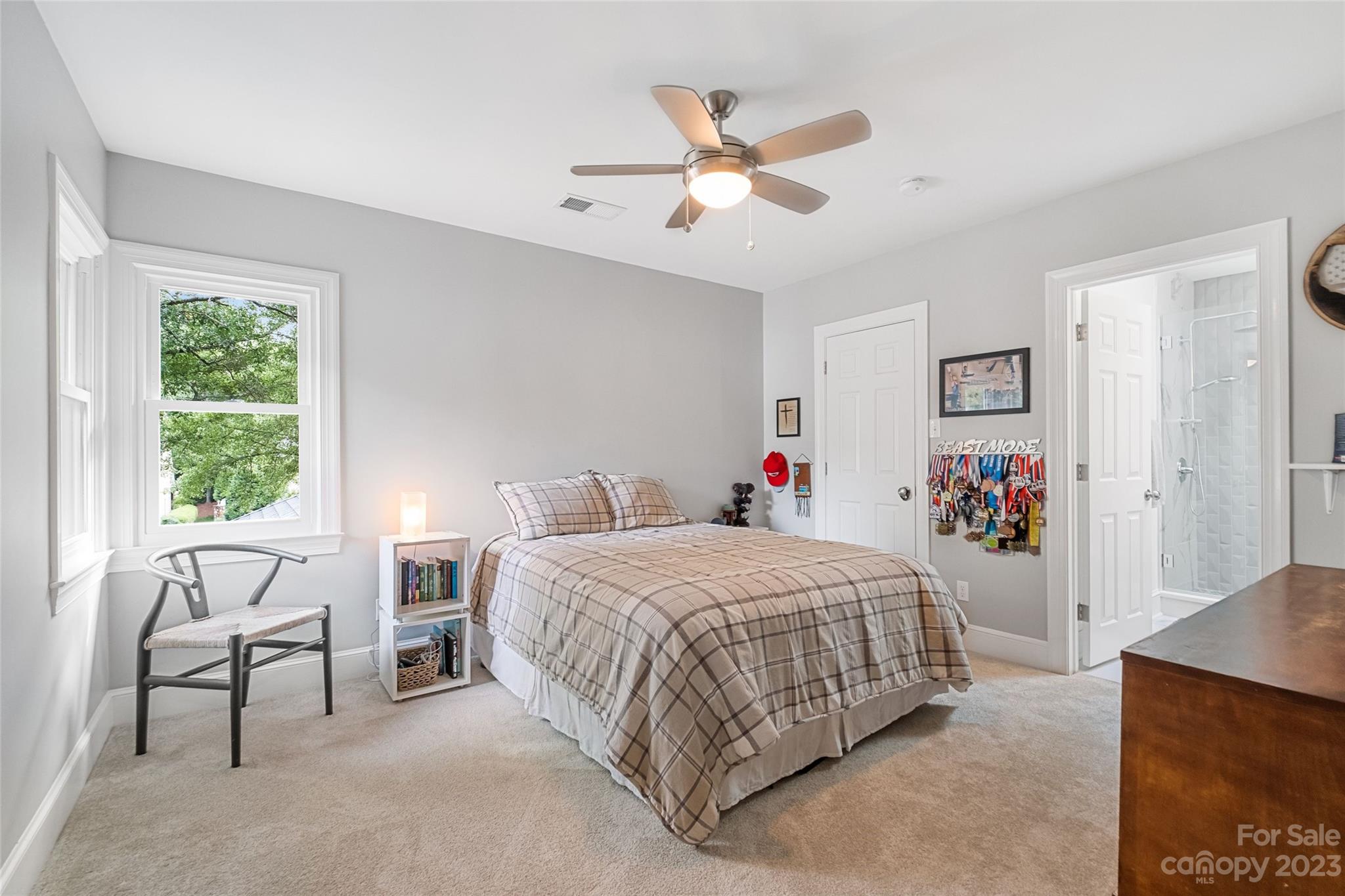 5013 Morrowick Road Charlotte, NC 28226 - Photo 30 of 48 a bedroom with a bed and a chandelier