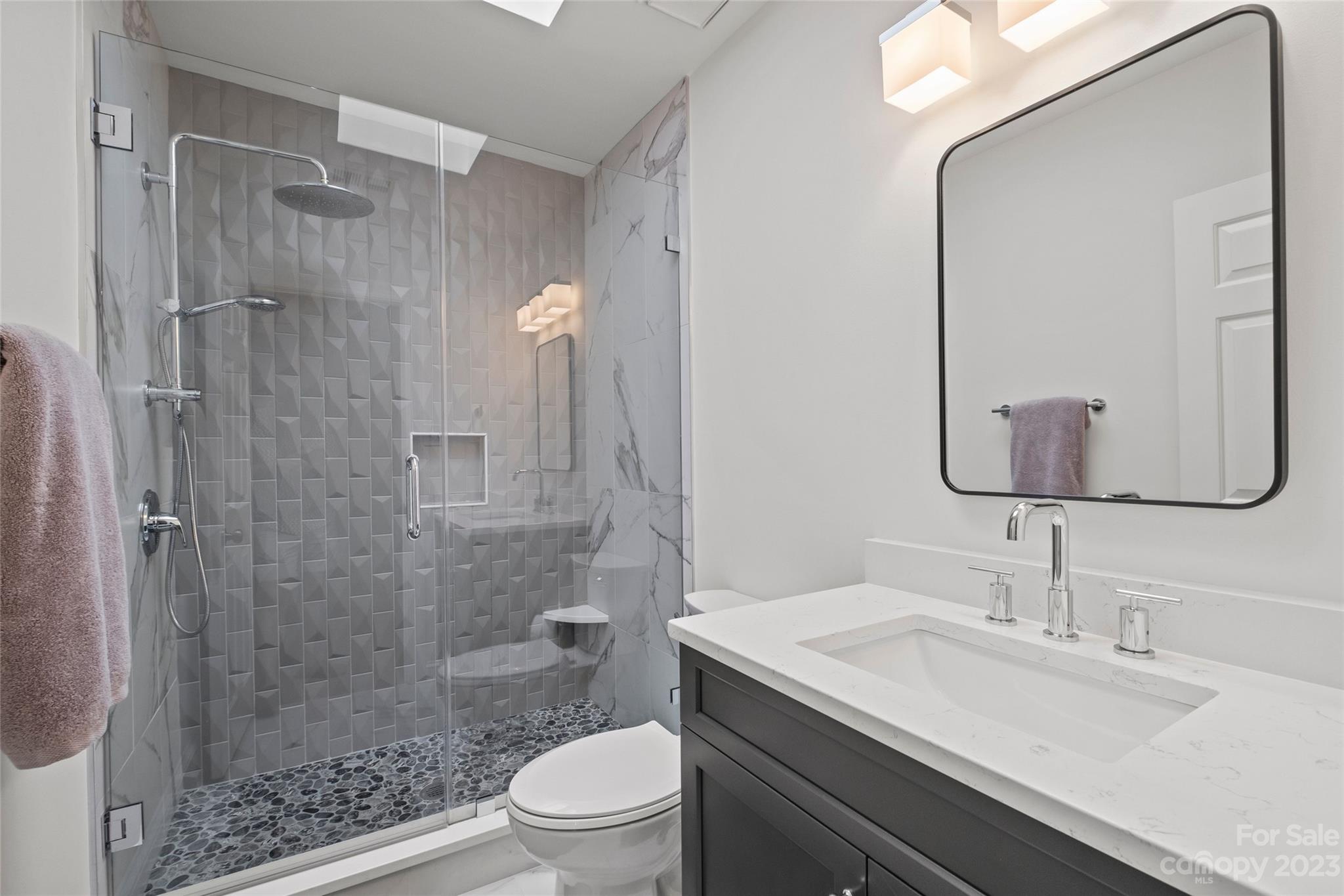 5013 Morrowick Road Charlotte, NC 28226 - Photo 31 of 48 a bathroom with a shower sink vanity mirror and toilet