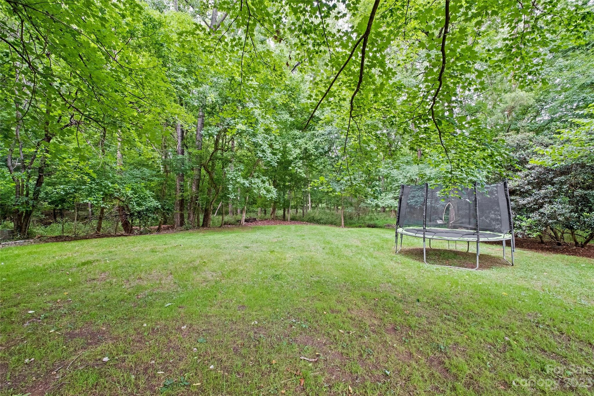 5013 Morrowick Road Charlotte, NC 28226 - Photo 46 of 48 a view of a backyard with wooden fence and a bench