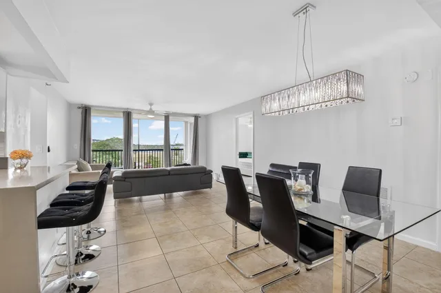 a living room with furniture and a floor to ceiling window