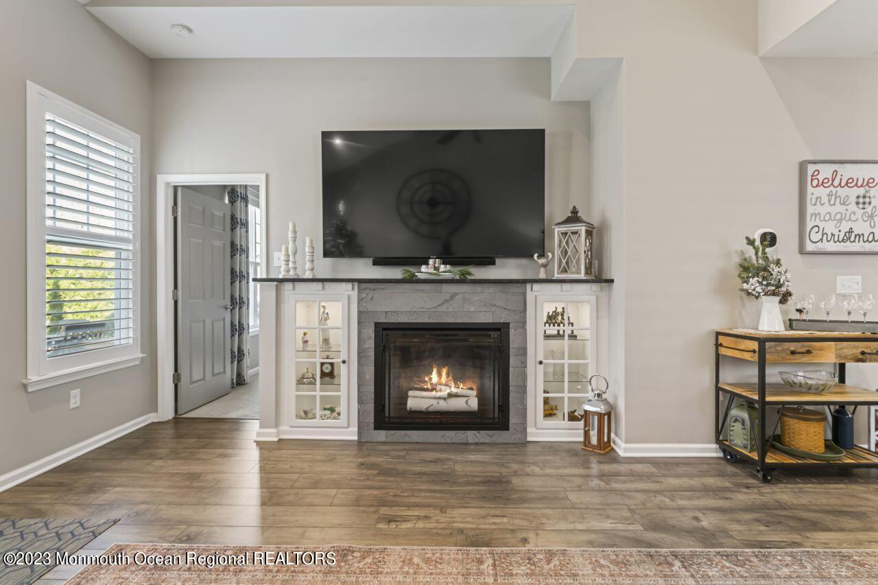 68 Harvest Ridge Road Howell, NJ 07731 - Photo 17 of 45 a living room with a fireplace and a flat screen tv