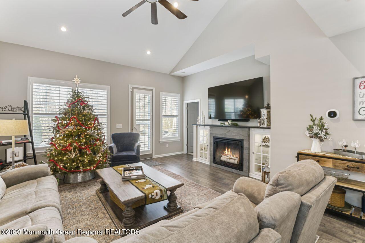 68 Harvest Ridge Road Howell, NJ 07731 - Photo 19 of 45 a living room with furniture a flat screen tv and a fireplace