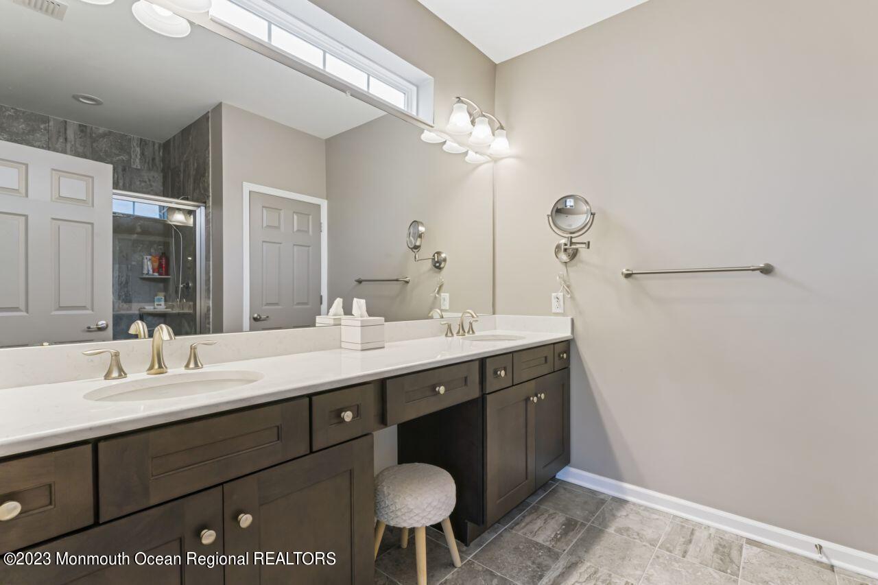 68 Harvest Ridge Road Howell, NJ 07731 - Photo 26 of 45 a bathroom with a sink a light fixture and a mirror