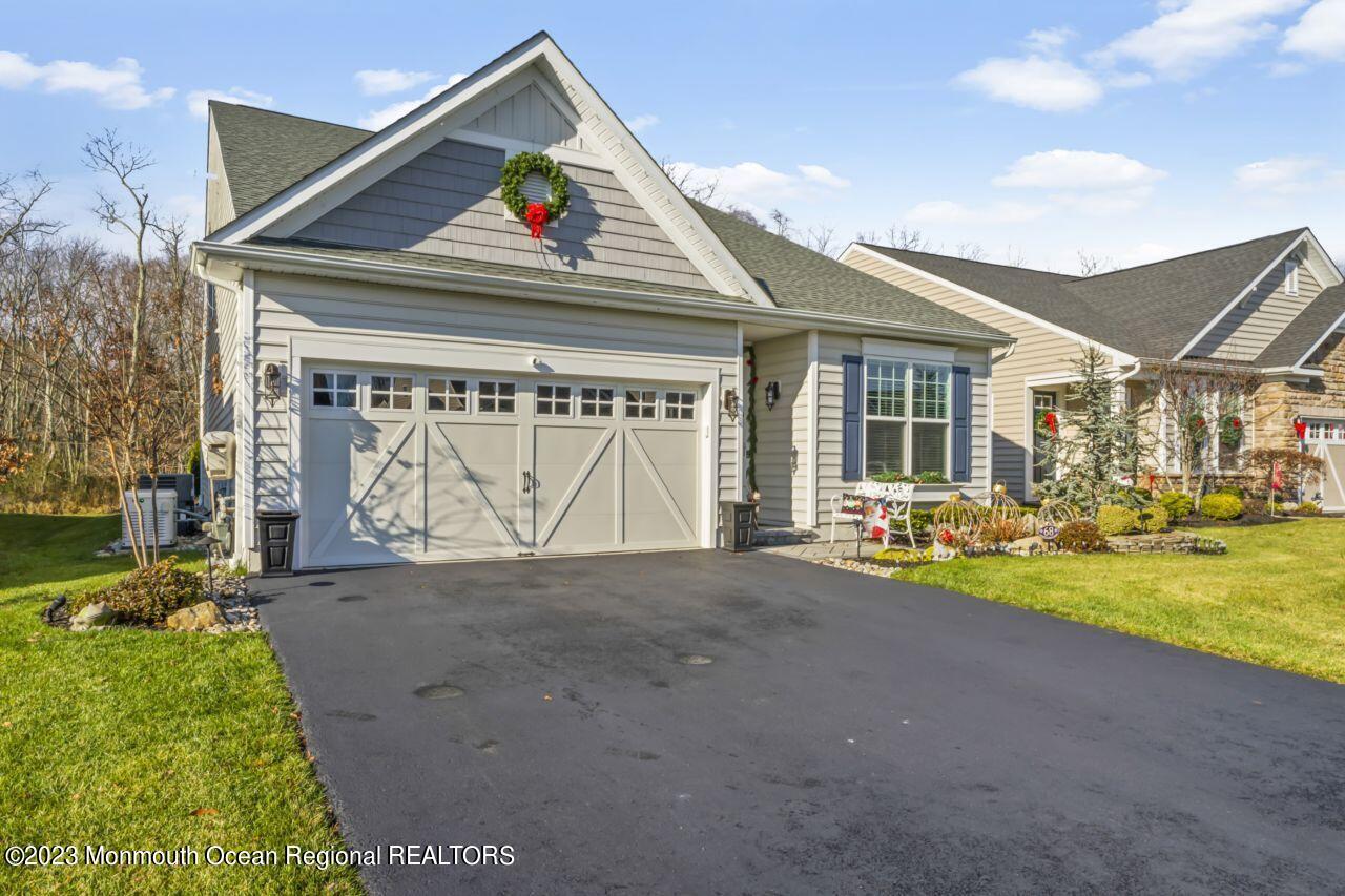68 Harvest Ridge Road Howell, NJ 07731 - Photo 3 of 45 a front view of a house with a yard and garage