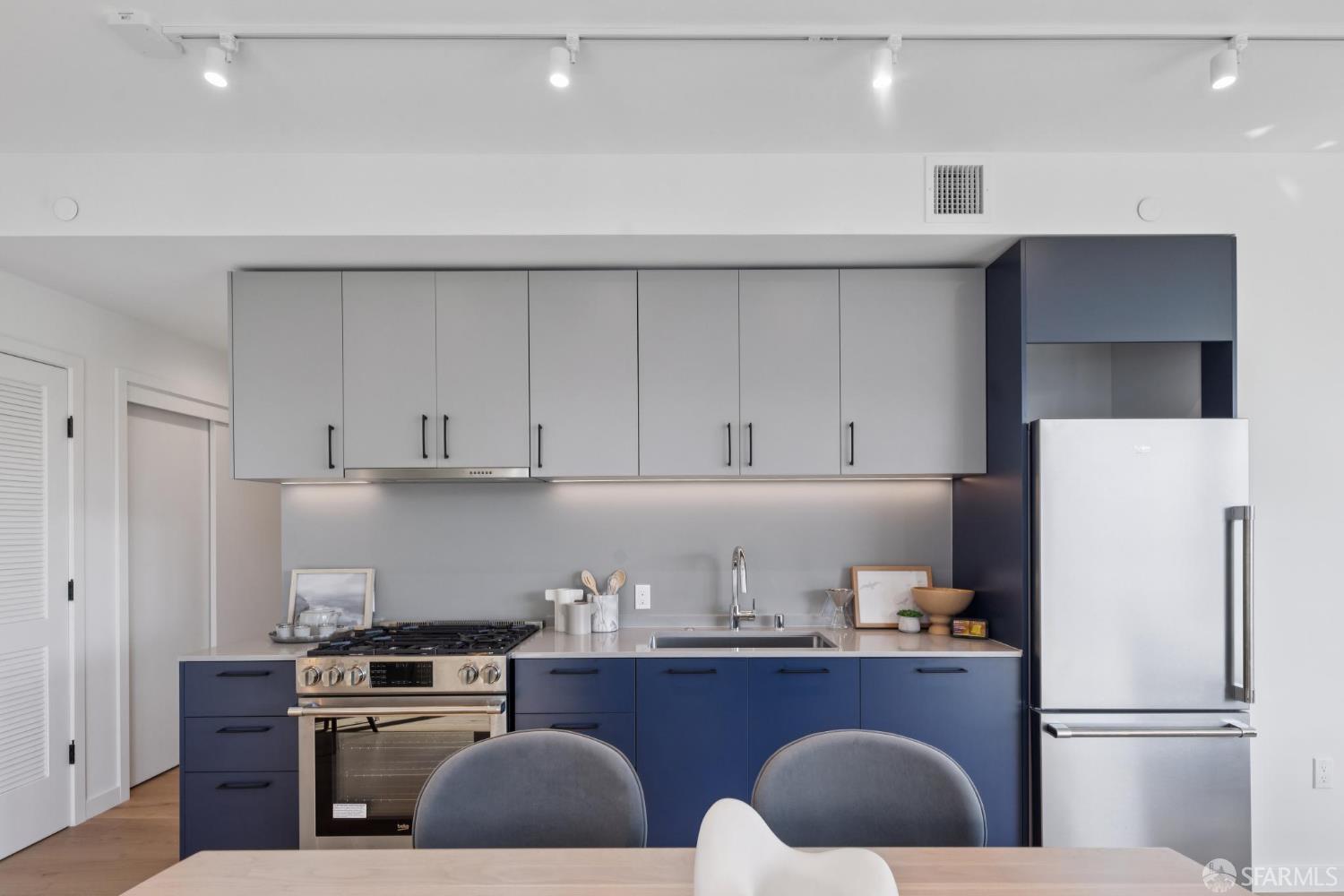 988 Harrison Street, Unit CN9 San Francisco, CA 94107 - Photo 2 of 16 a kitchen with cabinets a refrigerator and a stove
