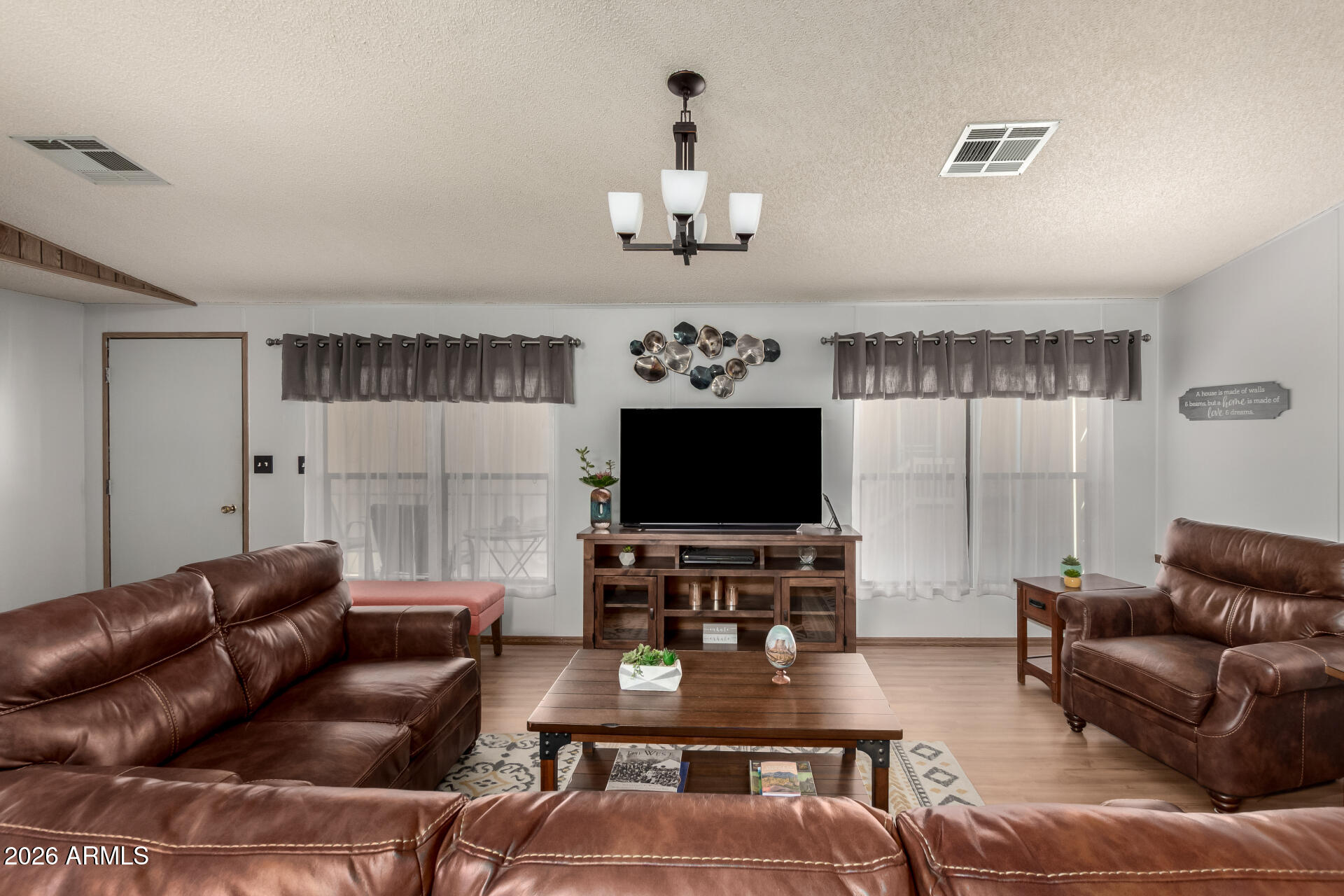 652 South Ellsworth Road, Unit 152 Mesa, AZ 85208 - Photo 12 of 30 a living room with furniture and a flat screen tv