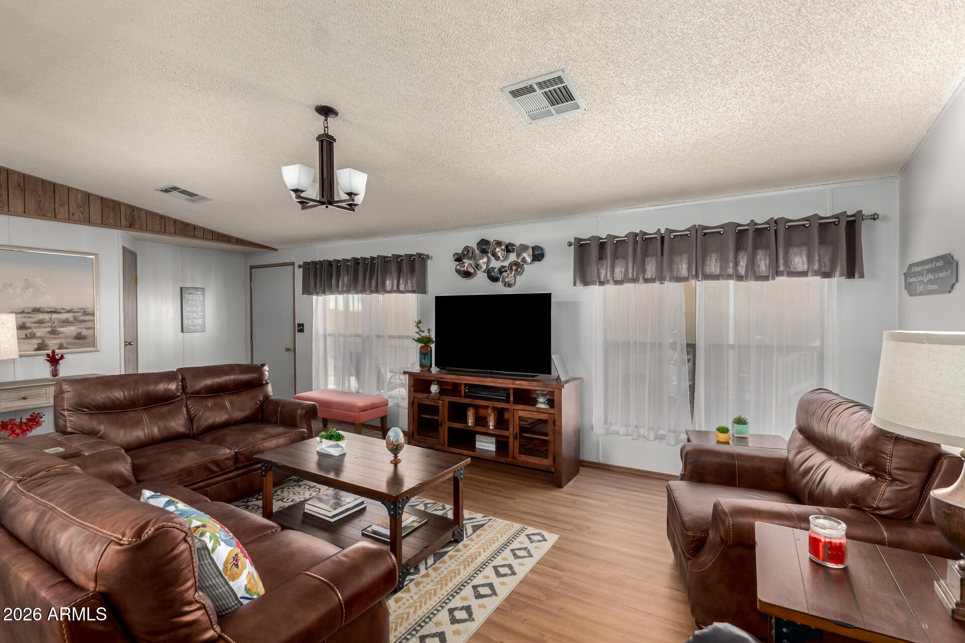 652 South Ellsworth Road, Unit 152 Mesa, AZ 85208 - Photo 13 of 30 a living room with furniture and a flat screen tv
