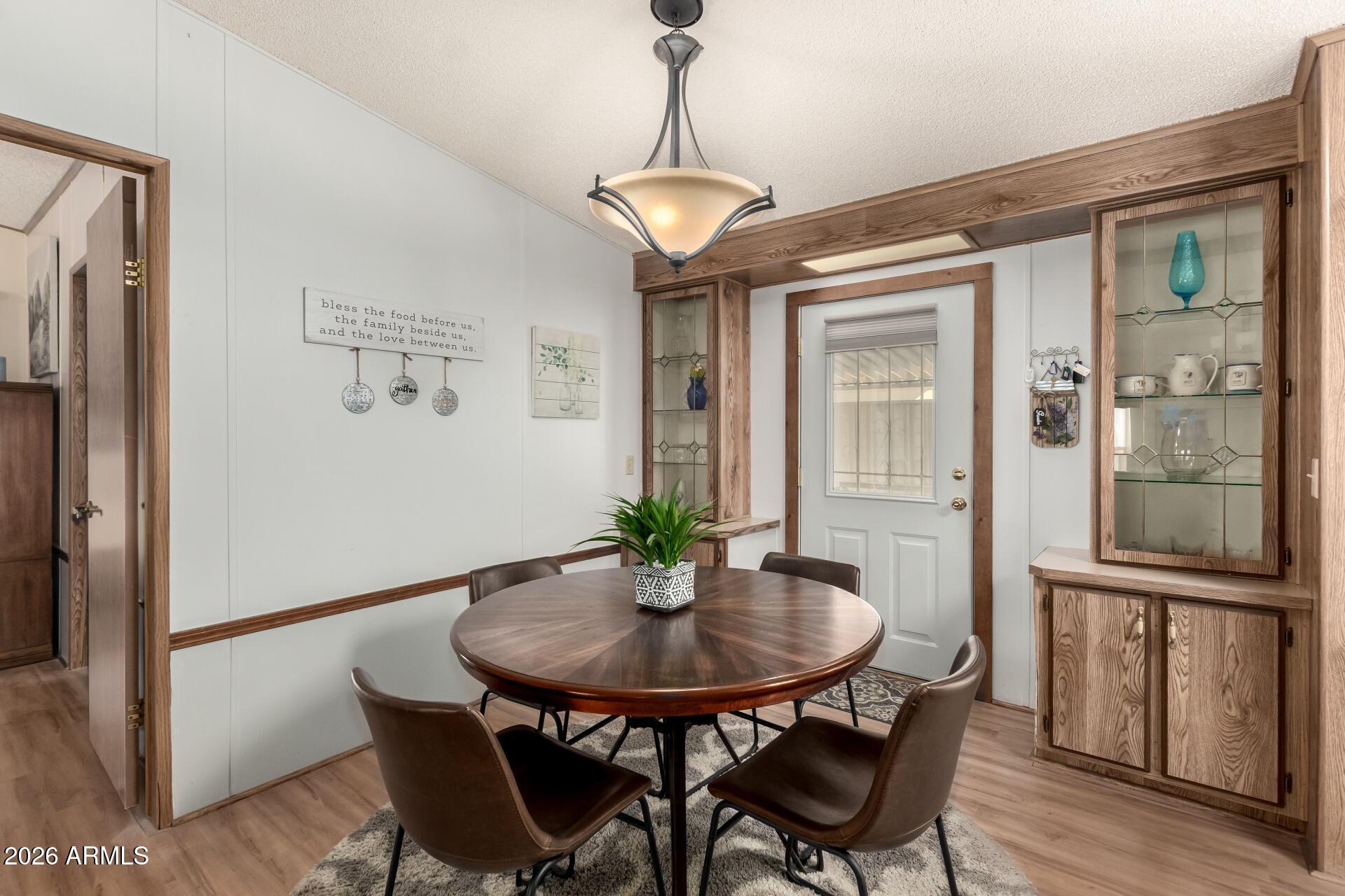 652 South Ellsworth Road, Unit 152 Mesa, AZ 85208 - Photo 14 of 30 a view of a dining room with furniture window and wooden floor